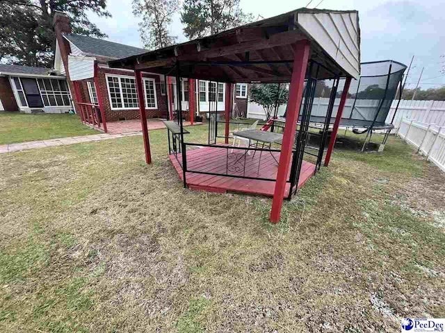 surrounding community featuring a yard and a trampoline