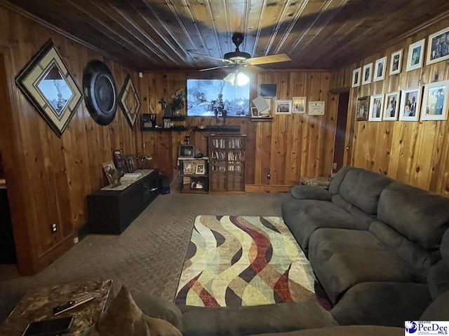 carpeted living room with ceiling fan, wooden ceiling, and wooden walls