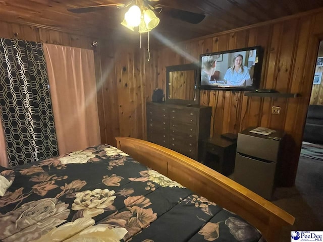 bedroom with wooden ceiling and wooden walls