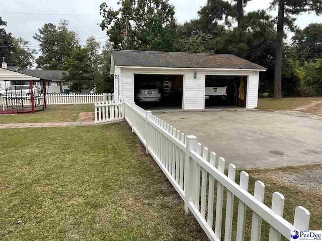 view of yard with a garage and an outdoor structure