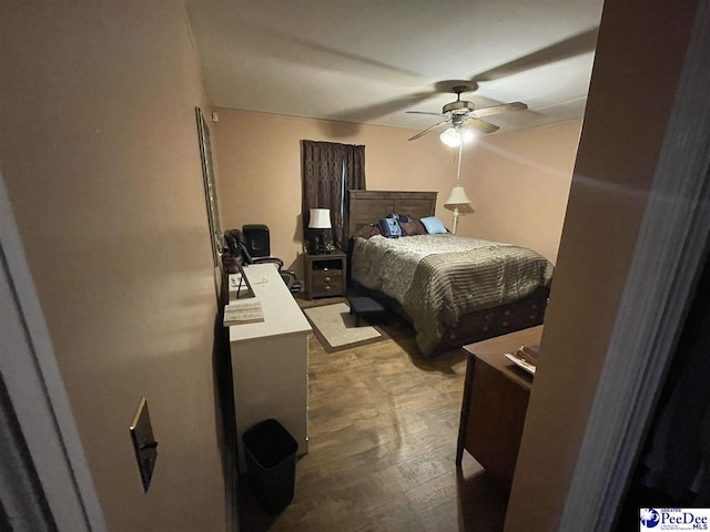 bedroom featuring light hardwood / wood-style floors and ceiling fan