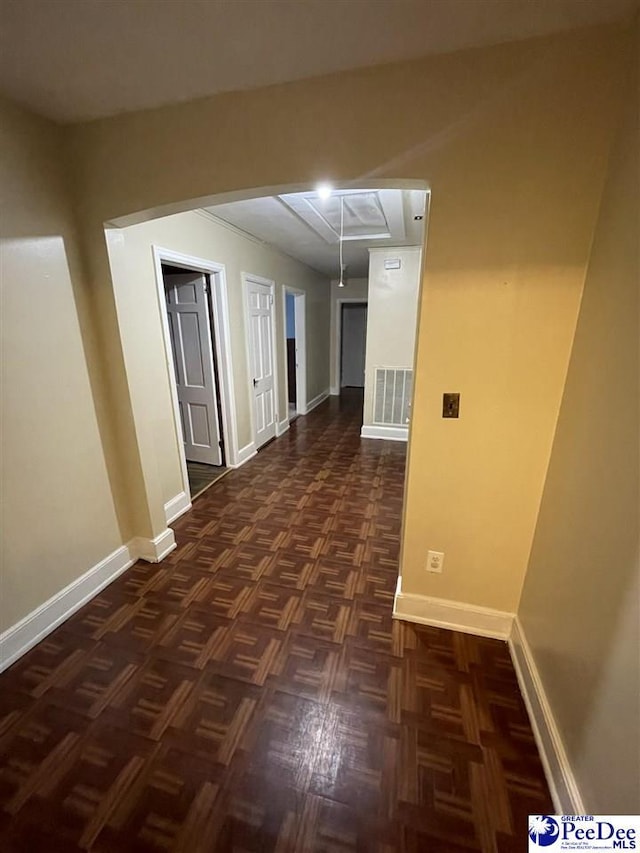 corridor with dark parquet flooring