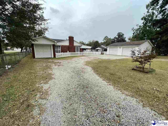 exterior space featuring a garage and a front lawn