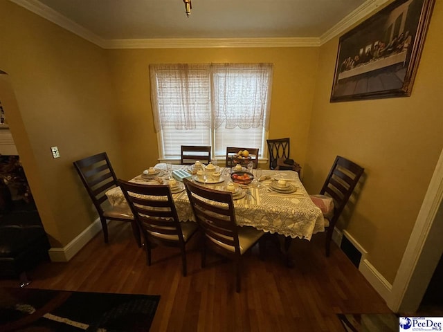 dining area featuring hardwood / wood-style flooring and ornamental molding