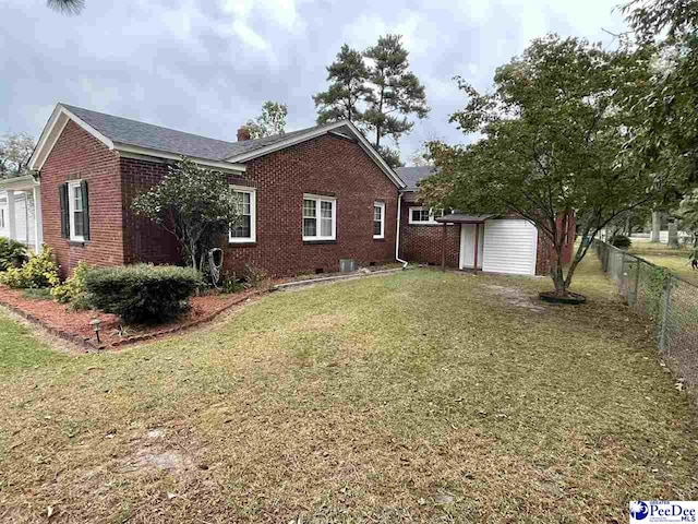 view of side of property with a lawn