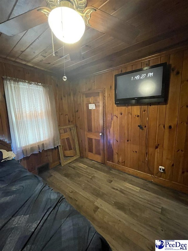 entrance foyer featuring hardwood / wood-style floors, wood ceiling, and wooden walls