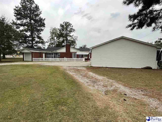 view of front of home with a garage and a front lawn