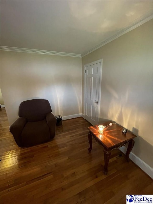 living area with ornamental molding and dark wood-type flooring