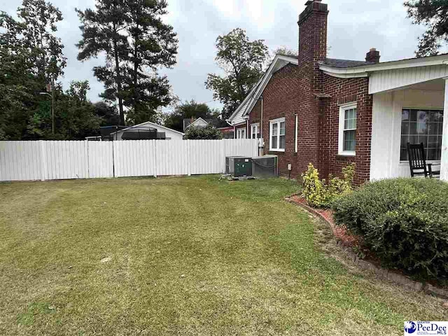 view of yard with central AC unit