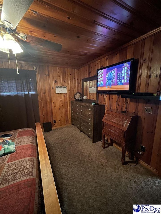 carpeted bedroom with wooden ceiling and wood walls