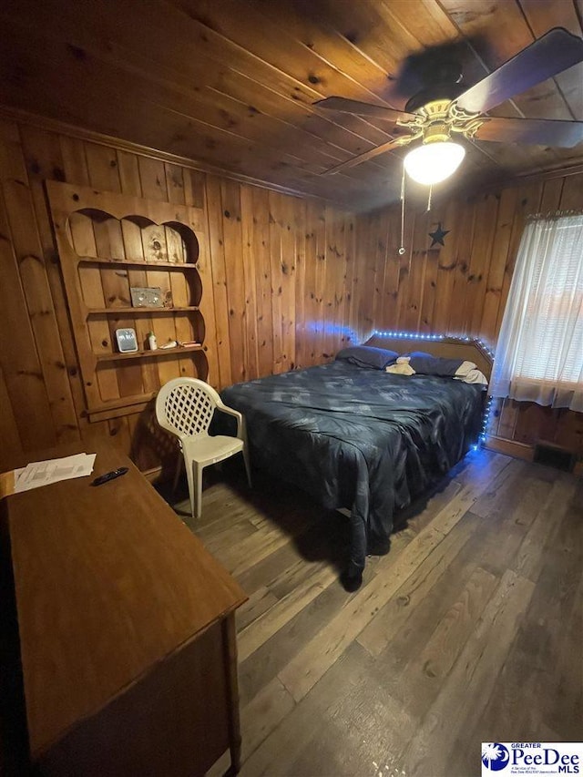 bedroom with wood ceiling, wooden walls, and hardwood / wood-style flooring