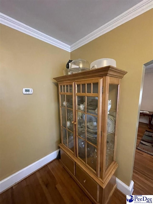 details with hardwood / wood-style flooring and crown molding