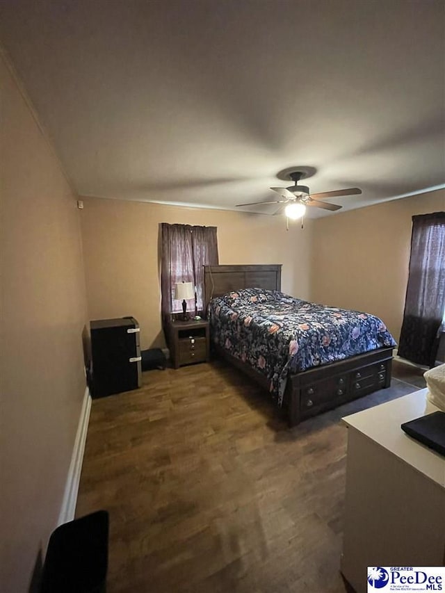 bedroom featuring dark wood-type flooring and ceiling fan