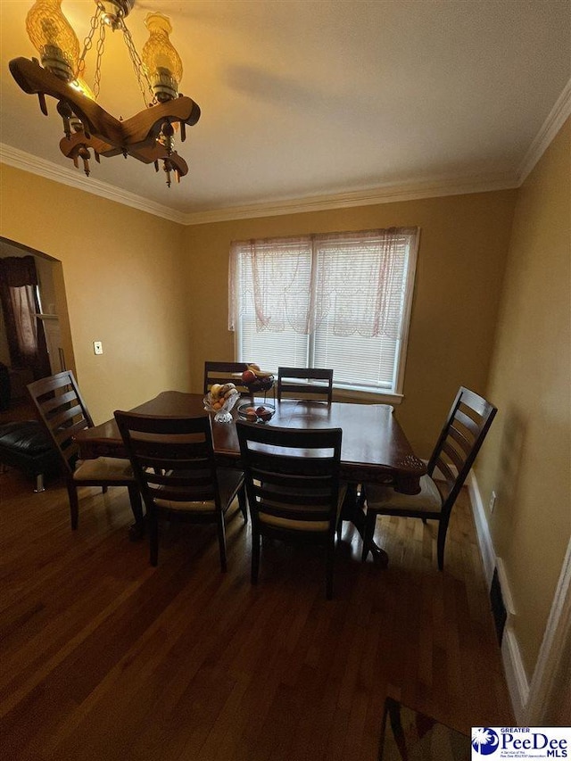 dining room featuring dark hardwood / wood-style flooring and crown molding