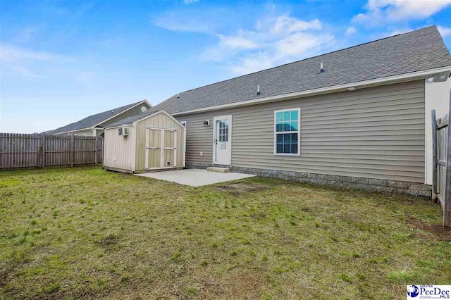 back of property featuring a patio, a yard, and a shed