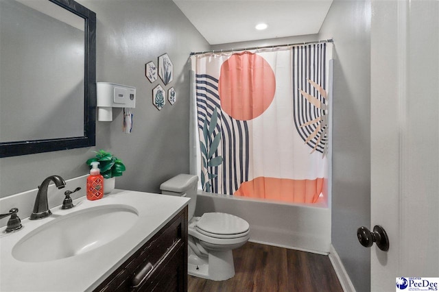 full bathroom with wood-type flooring, toilet, shower / bath combination with curtain, and vanity