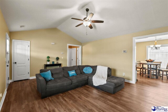 living room with lofted ceiling, dark hardwood / wood-style flooring, and ceiling fan with notable chandelier