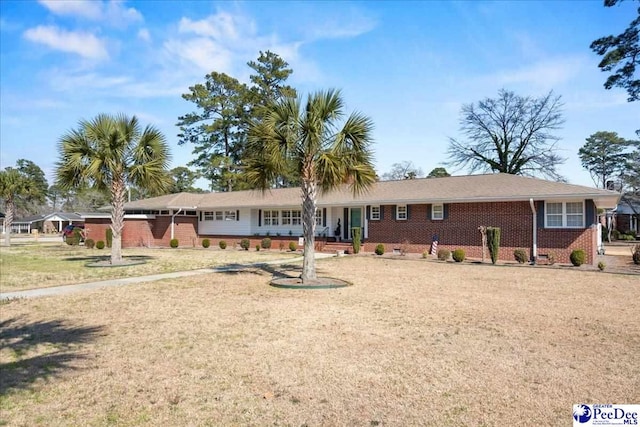 ranch-style house featuring brick siding