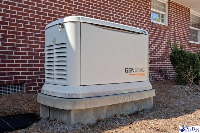 exterior details with a power unit and brick siding