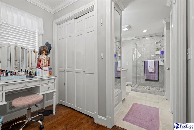 full bath featuring a shower stall, crown molding, and vanity