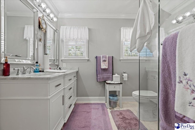 bathroom featuring double vanity, baseboards, toilet, ornamental molding, and a sink