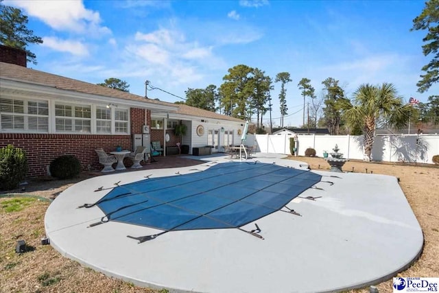 view of pool featuring a fenced in pool, a patio area, and fence