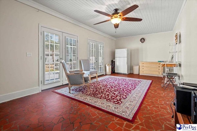 sitting room with baseboards, wooden ceiling, ceiling fan, crown molding, and french doors