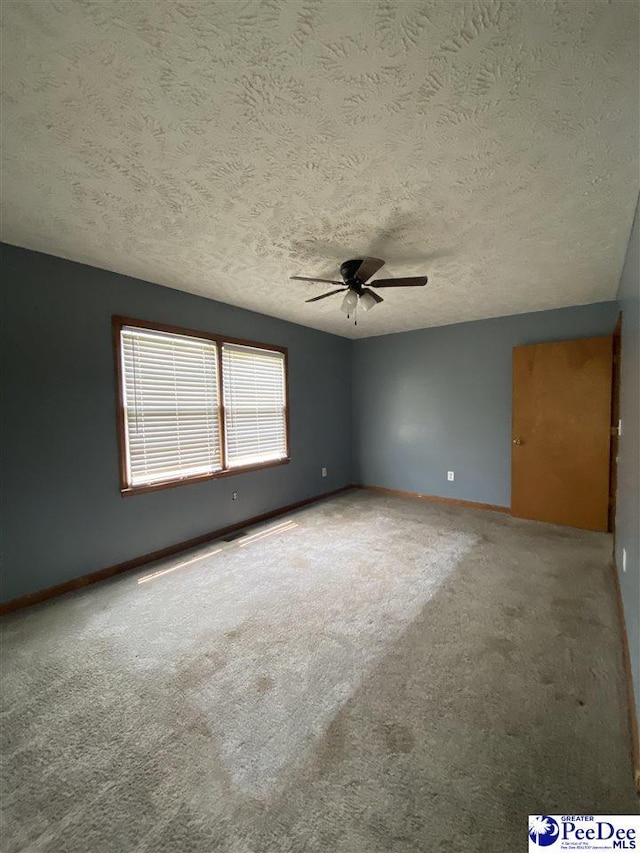 2266 Mack Arthur Rd, Mullins, SC 29574 - spare room featuring ceiling fan, baseboards, a textured ceiling, and carpet