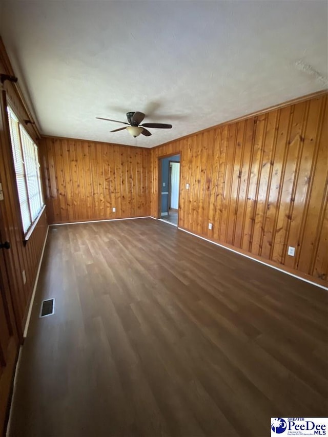2266 Mack Arthur Rd, Mullins, SC 29574 - unfurnished living room with dark wood finished floors, a ceiling fan, baseboards, and wooden walls