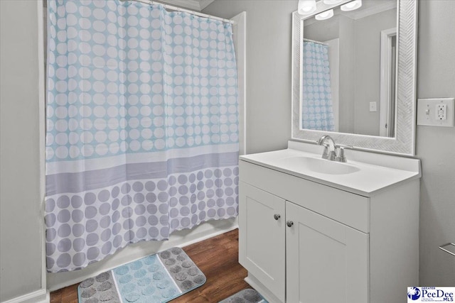 bathroom with curtained shower, wood finished floors, and vanity