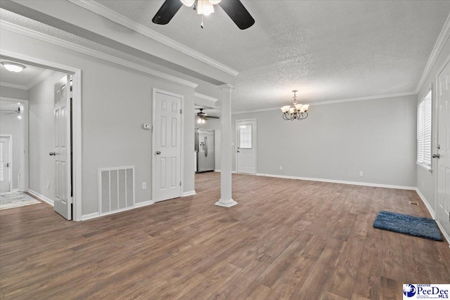 unfurnished living room with visible vents, ornamental molding, wood finished floors, decorative columns, and ceiling fan with notable chandelier