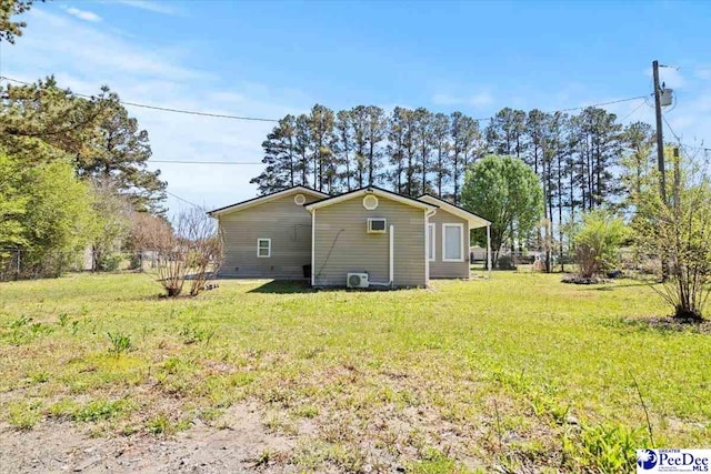 rear view of property with a lawn and fence