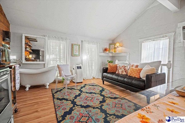 living room featuring high vaulted ceiling and light wood-type flooring