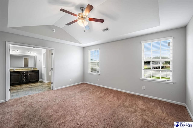 1224 Barn Owl Rd, Effingham, SC 29541 - unfurnished bedroom featuring light colored carpet, baseboards, lofted ceiling, ensuite bath, and a ceiling fan