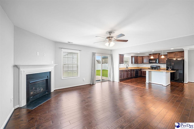 1224 Barn Owl Rd, Effingham, SC 29541 - unfurnished living room with ceiling fan, baseboards, dark wood-style floors, and a fireplace with flush hearth