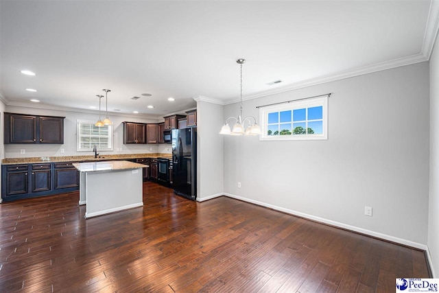 1224 Barn Owl Rd, Effingham, SC 29541 - kitchen with black appliances, baseboards, ornamental molding, dark wood finished floors, and a sink
