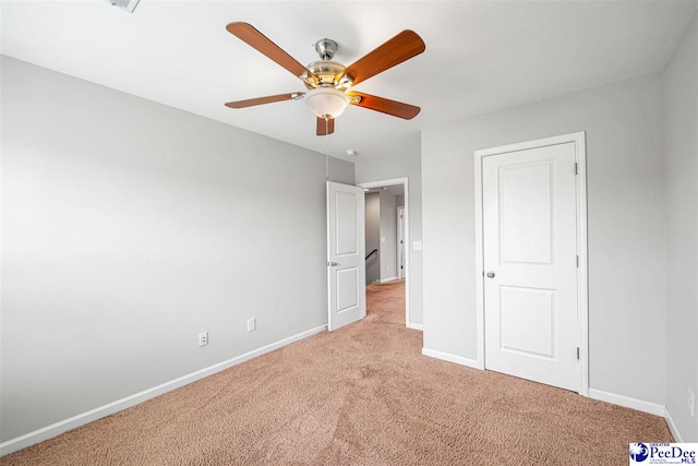 1224 Barn Owl Rd, Effingham, SC 29541 - unfurnished bedroom featuring light carpet, baseboards, and ceiling fan