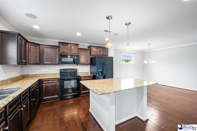 1224 Barn Owl Rd, Effingham, SC 29541 - kitchen with black appliances, crown molding, dark brown cabinetry, a kitchen island, and light stone counters