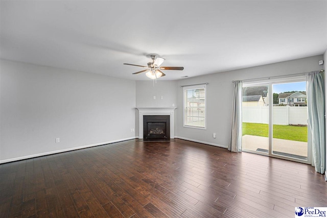 1224 Barn Owl Rd, Effingham, SC 29541 - unfurnished living room featuring ceiling fan, dark wood-style floors, a fireplace with flush hearth, and baseboards