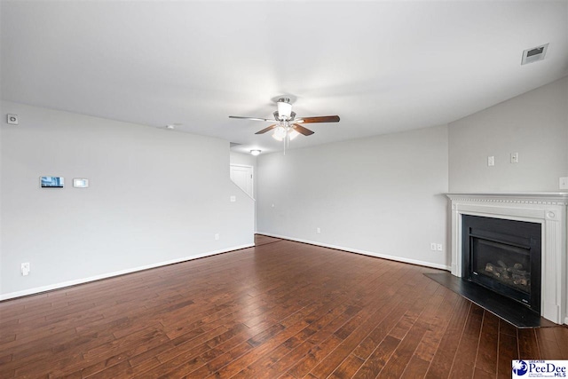 1224 Barn Owl Rd, Effingham, SC 29541 - unfurnished living room featuring a ceiling fan, a glass covered fireplace, dark wood finished floors, and baseboards