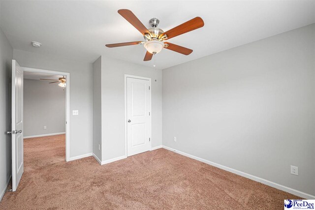 1224 Barn Owl Rd, Effingham, SC 29541 - unfurnished bedroom with light colored carpet, baseboards, and ceiling fan