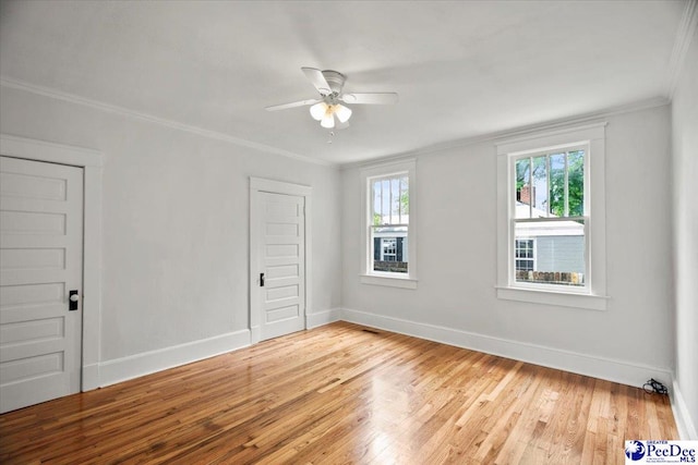 701 S Coit St, Florence, SC 29501 - unfurnished room with light wood-style flooring, ornamental molding, a ceiling fan, and baseboards
