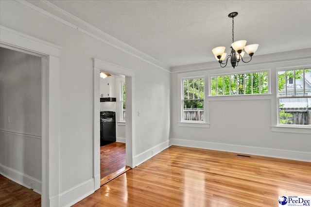 701 S Coit St, Florence, SC 29501 - unfurnished dining area featuring a chandelier, wood finished floors, crown molding, baseboards, and a textured ceiling