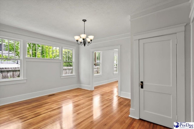 701 S Coit St, Florence, SC 29501 - empty room featuring a chandelier, crown molding, a textured ceiling, light wood finished floors, and baseboards