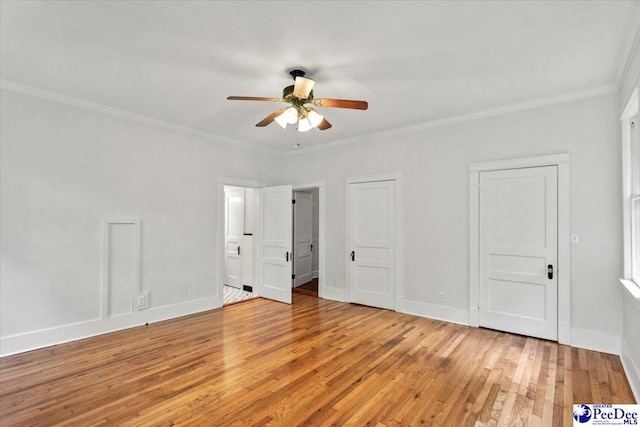 701 S Coit St, Florence, SC 29501 - unfurnished bedroom featuring light wood-style flooring, ornamental molding, baseboards, ensuite bathroom, and ceiling fan