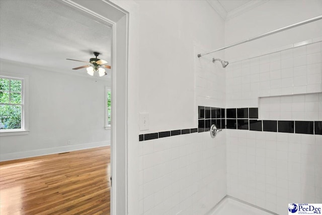 701 S Coit St, Florence, SC 29501 - bathroom with ornamental molding, plenty of natural light, a tile shower, ceiling fan, and wood finished floors