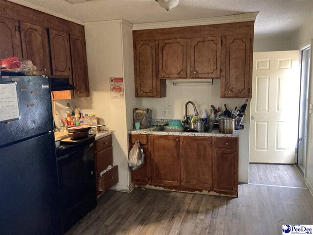 606 Curry St, Dillon, SC 29536 - kitchen featuring dark hardwood / wood-style flooring, sink, and black appliances