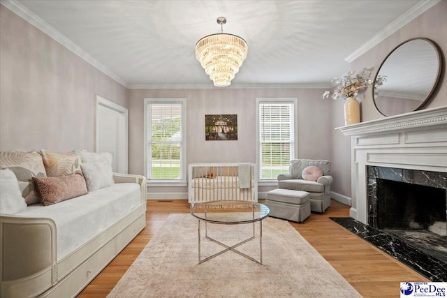 living room featuring crown molding, a fireplace, and light hardwood / wood-style floors