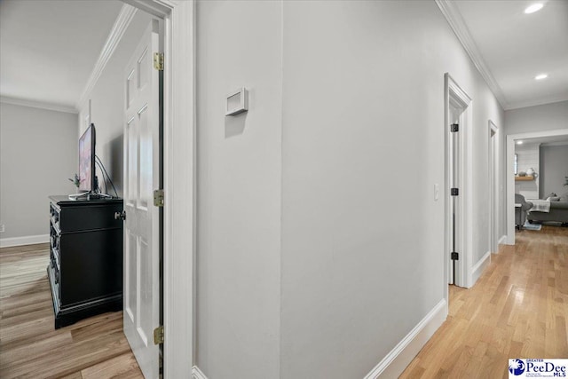 hall featuring crown molding and light wood-type flooring