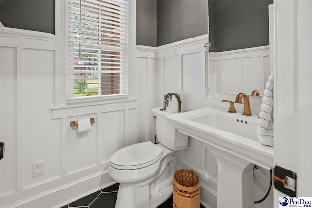 bathroom featuring tile patterned flooring and toilet